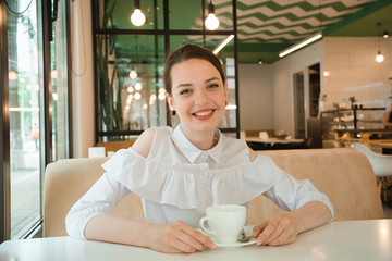 business girl drinks a drink in a cup