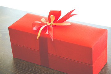 Red gift box with red and gold ribbon