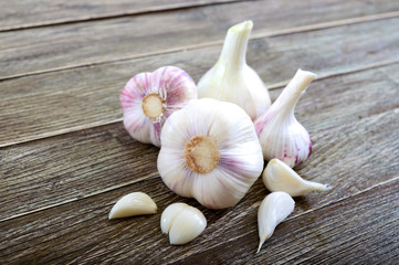 Garlic cloves, garlic bulb on wooden background. Fresh garlic close up. Concept of healthy food.