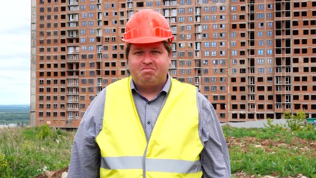 Young builder says No. By shaking his head. Worker says No, meaning No. Construction site