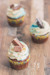Handmade chocolate muffins with decorations on the wooden background