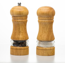 Salt container and pepper mill isolated on white. Sets for spices. Dishes.