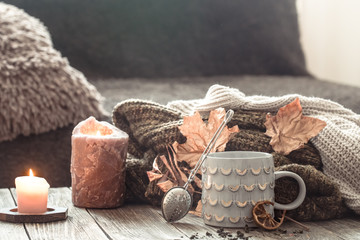 Cozy autumn morning breakfast in bed still life scene. Steaming cup of hot coffee, tea standing near window. Fall.