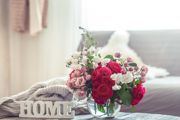 Still life with an inscription home and a vase of flowers