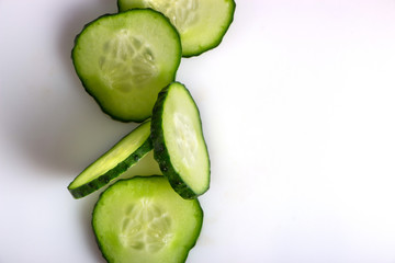 fresh green cucumber, cut with rings on a white background