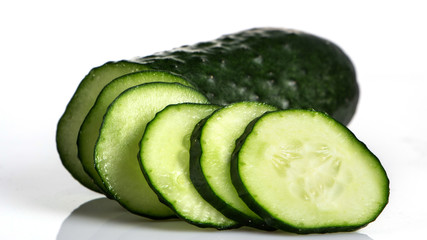 fresh green cucumber, cut with rings on a white background