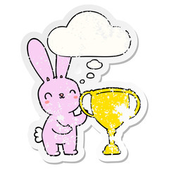 cute cartoon rabbit with sports trophy cup and thought bubble as a distressed worn sticker