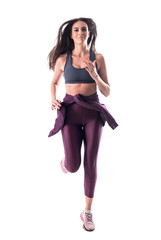 Action shot of young attractive fit woman athlete running and looking at camera. Full body isolated on white background. 