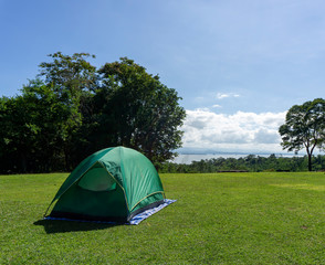 Green tent Spread on the grass at the tent-spreading spot of Huai Mae Khamin Waterfall, Kanchanaburi, Thailand.