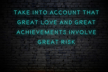Neon inscription of positive wise motivational quote against brick wall 