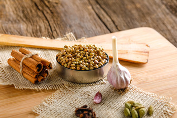 Colorful mix of different spices  on a wooden board