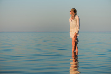 young woman in white clothes portrait at summer seascape horizon 