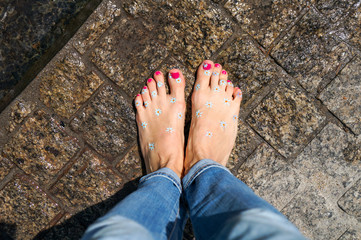 Young barefoot woman walking in the city