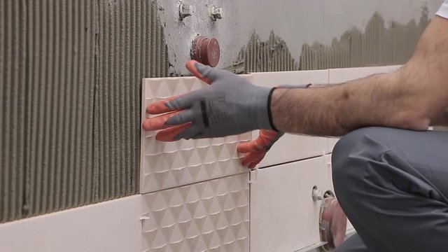 Laying tiles in bathroom