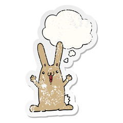 cartoon rabbit and thought bubble as a distressed worn sticker