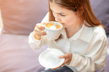 close up of beautiful  woman is drinking coffee