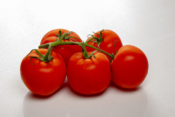 branch of cherry tomatoes on a white background