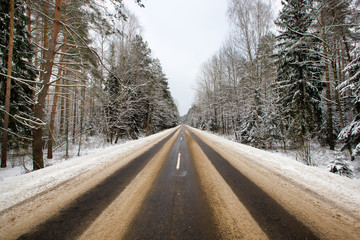 details of the snow-covered road in forest