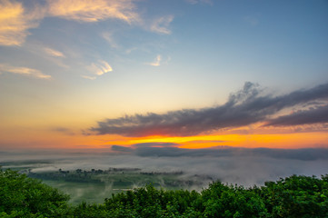 Dawn on a misty morning on a mountain above the river