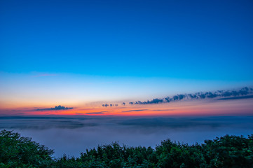 Dawn on a misty morning on a mountain above the river