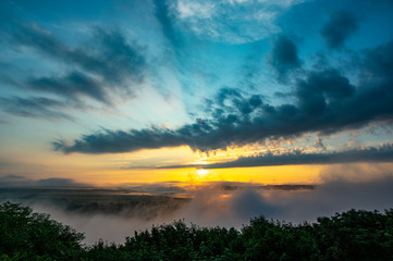 Obraz premium Dawn on a misty morning on a mountain above the river