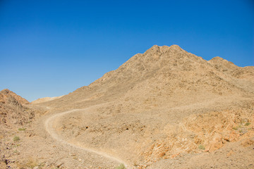 Argentina south American Patagonia desert dry wilderness scenery landscape with sand stone rocky mountain and ground lonely trail path way through this dangerous environment 