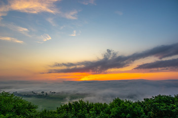 Fototapeta na wymiar Dawn on a misty morning on a mountain above the river