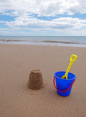 Child's bucket and spade with sandcastle, Bridlington beach