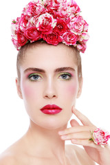 Young beautiful woman with bright fresh makeup and flowers in her hair