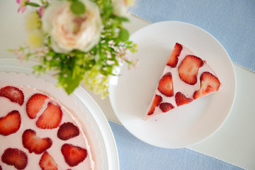 Fresh cheesecake with strawberries on a table