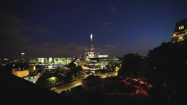 Timelapse of the Shard in London, UK. Cars are going by, The Lights from the City Light up the Sky Above this Amazing Building.