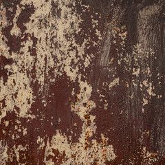 Old shabby rusty metal wall. Shabby, cracked brown paint. Grunge background