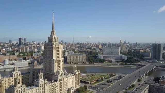 Aerial view of hotel Ukraine in Moscow. Old Soviet Russia Stalin high-rise skyscrapers in heart of modern Moscow City. Kutuzov avenue day traffic.