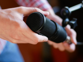 hand holding the studio microphone, musical set up. concert preparation