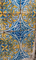 Old, hand painted traditional Portuguese tiles in yellow, blue & white. taken in Cascais.