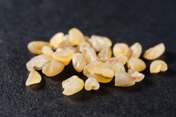 Brown brown rice with bran shell on a dark background, close-up. Macro shooting.