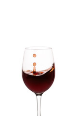 splash of red wine in glass isolated on white background.