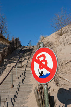 Coast Belgium. Dunes and warning sign