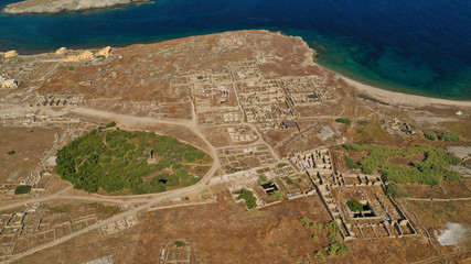 Aerial drone panoramic distant view of famous archaeological site a whole ancient citadel in island of Delos, Cyclades, Greece