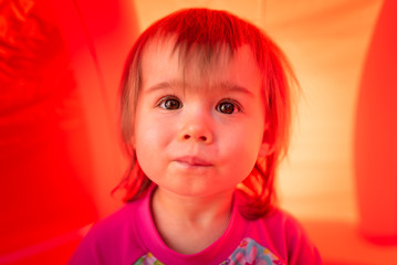 Cute baby girl with big brown eyes outdoors portrait