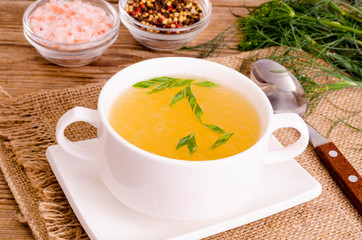 Chicken broth soup in white plate. Photo