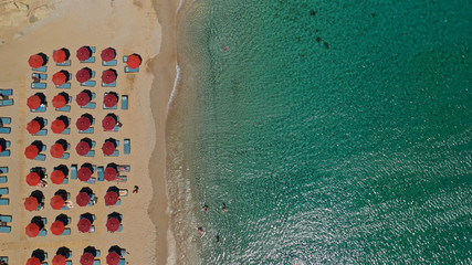 Aerial drone photo of famous organised with sun beds and umbrellas beach of Lia with emerald clear...