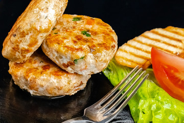 homemade meatballs, cutlets fried from red and white fish meat, in a vintage rustic bowl plate,...