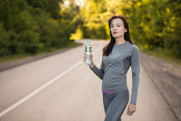 drink water while jogging. girl running.