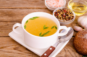 Chicken broth soup in white plate. Photo