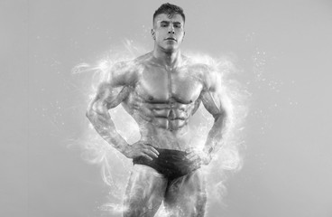 Brutal strong muscular bodybuilder athlete man pumping up muscles on white background. Workout bodybuilding concept. Black and white photo.