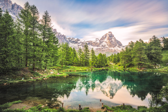 The blue lake and the Matterhorn in a scenic summer landscape with sunny lights seen from Breuil-Cervinia, Aosta Valley - Italy