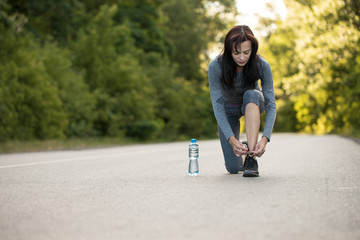 tie the lace of sports shoes. girl running