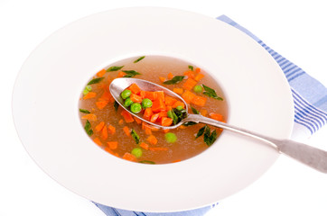 Dietary vegetable soup with carrots, peas and green onions. 