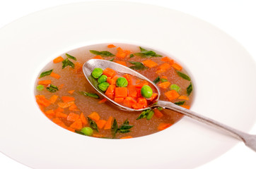 Dietary vegetable soup with carrots, peas and green onions. 